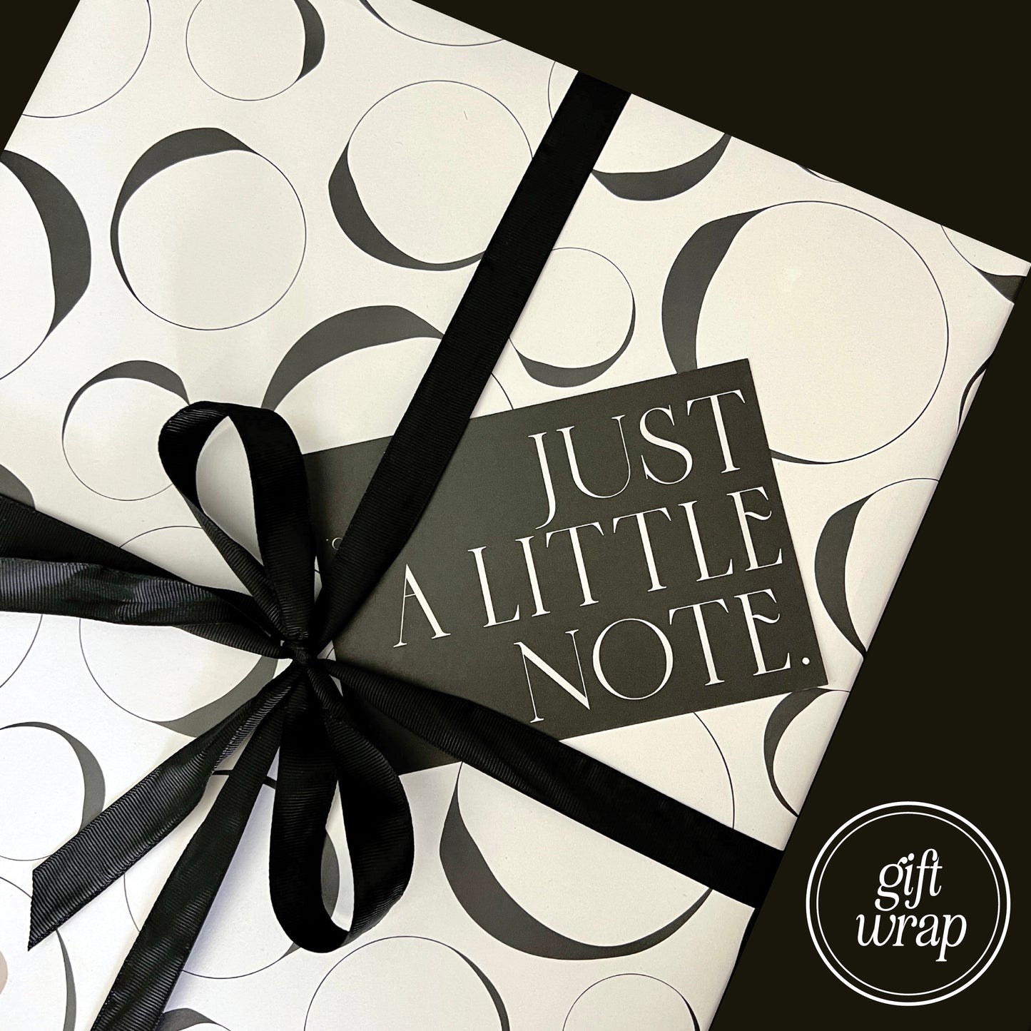 Example of gift wrapping used when paid for. White and black Aballone Paper, finished with black ribbon and gift note