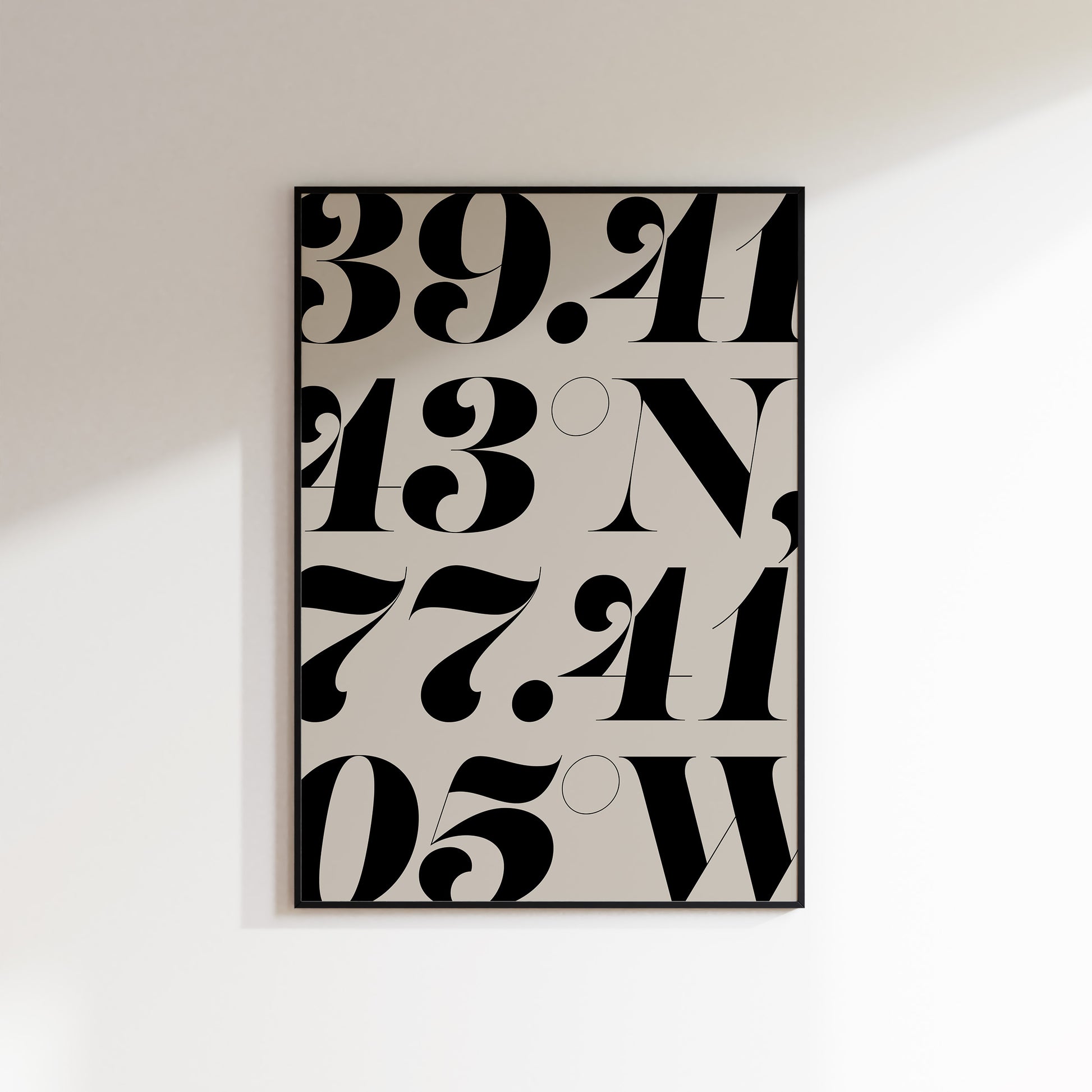 A location coordinate print for the home, ideal for hallways, living rooms and bedrooms. This is a neutral beige coloured print with slate coloured number coordinates falling off all edges of the print in a bold serif typeface. Print is in a black frame on a white wall background.