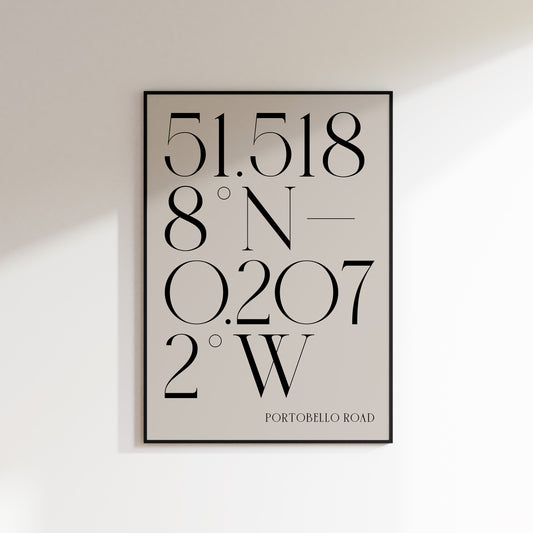 A location coordinate print for the home, ideal for hallways, living rooms and bedrooms. This is a neutral beige coloured print with slate coloured number coordinates in a deco style serif typeface. Print is in a black frame on a white wall background.